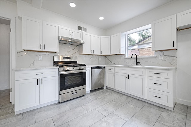 kitchen featuring white cabinetry, sink, backsplash, and stainless steel appliances