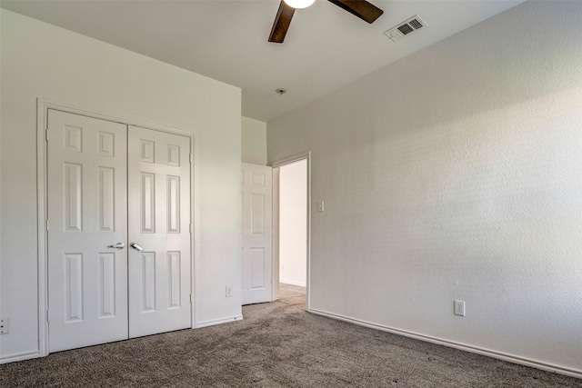 unfurnished bedroom with carpet, ceiling fan, and a closet