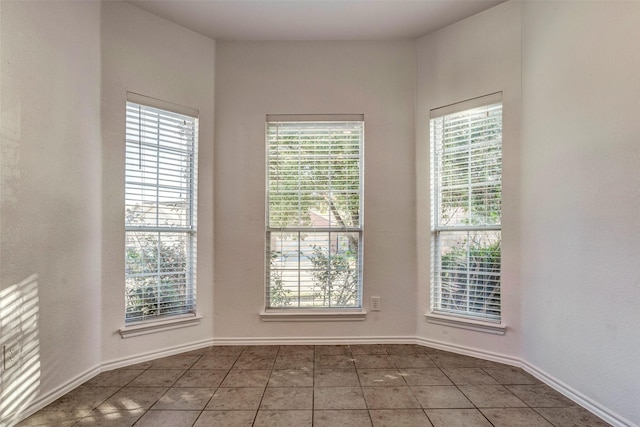 unfurnished room featuring tile patterned flooring