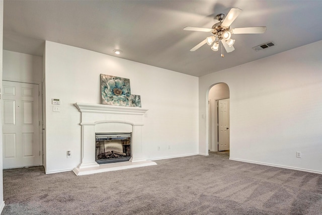 unfurnished living room featuring carpet and ceiling fan