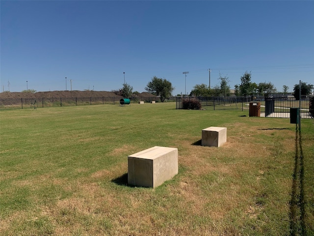 view of yard featuring fence and a rural view