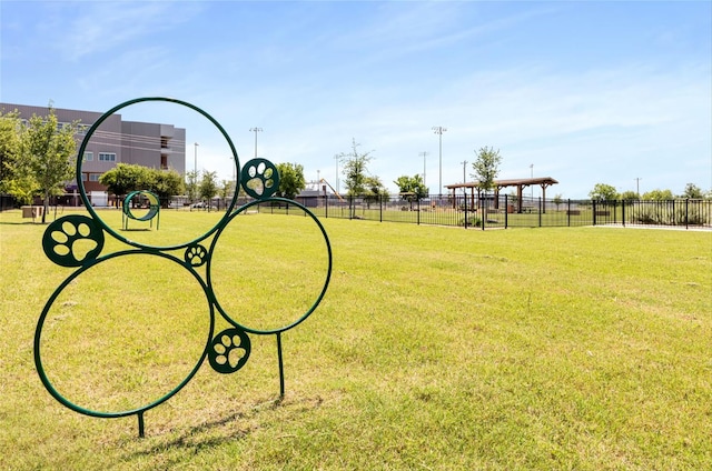 view of home's community featuring a lawn and fence