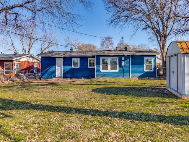 rear view of property with a storage unit and a lawn