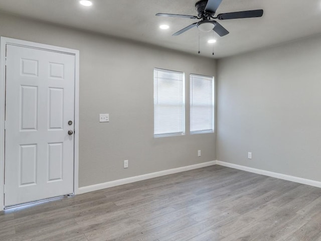 empty room featuring ceiling fan and light hardwood / wood-style floors