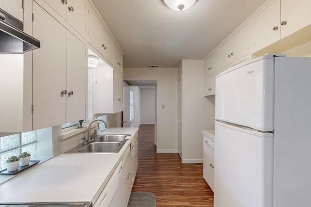 kitchen with sink, white appliances, white cabinetry, crown molding, and dark hardwood / wood-style flooring