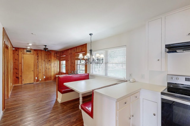 kitchen featuring stainless steel electric stove, dark wood-type flooring, white cabinets, kitchen peninsula, and ventilation hood