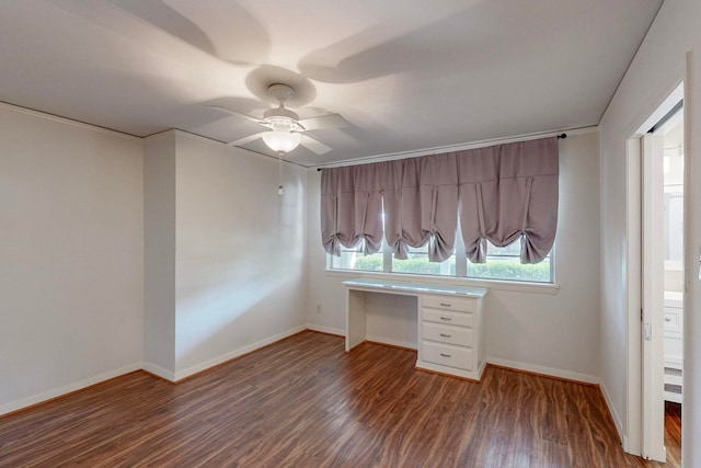 interior space featuring built in desk, ceiling fan, and dark wood-type flooring