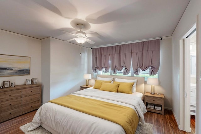 bedroom featuring ensuite bath, ceiling fan, and dark hardwood / wood-style flooring