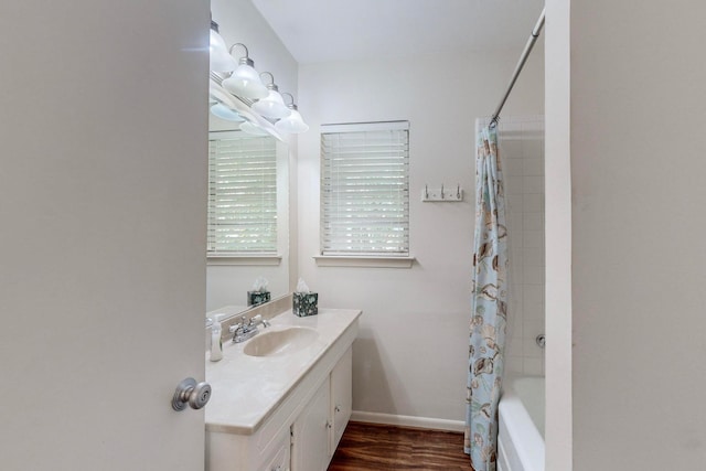 bathroom featuring vanity, hardwood / wood-style flooring, and shower / tub combo with curtain