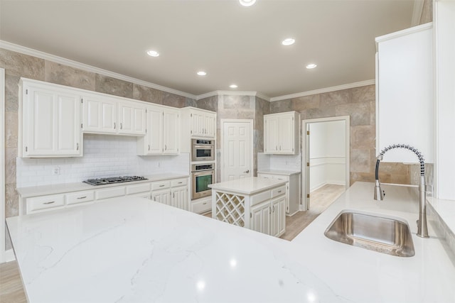 kitchen with light hardwood / wood-style floors, white cabinetry, sink, and stainless steel appliances