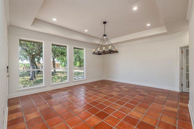 tiled empty room with a tray ceiling and crown molding