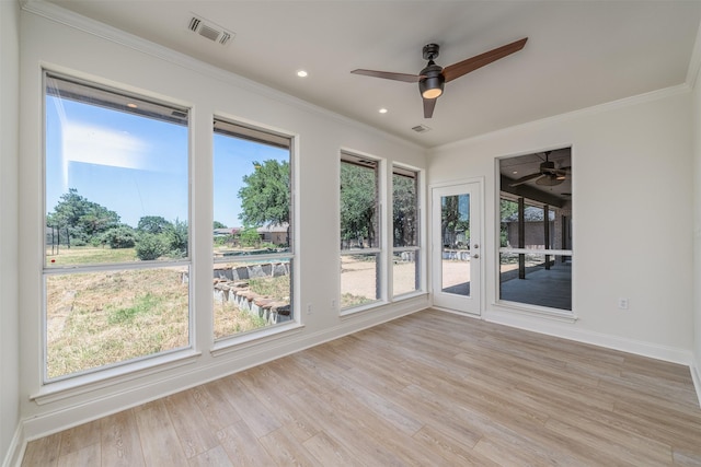 unfurnished sunroom with ceiling fan