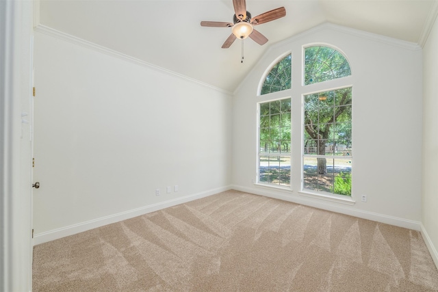 carpeted empty room featuring ceiling fan, lofted ceiling, and ornamental molding