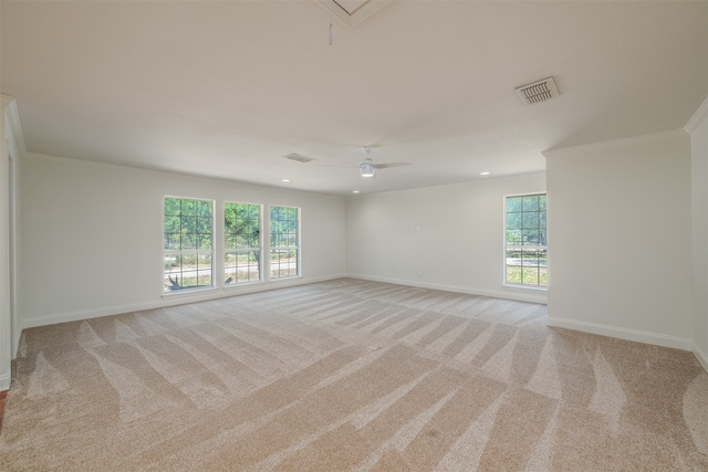 carpeted spare room featuring crown molding, plenty of natural light, and ceiling fan