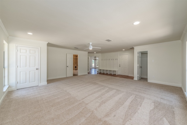 unfurnished living room with light carpet, ceiling fan, and crown molding