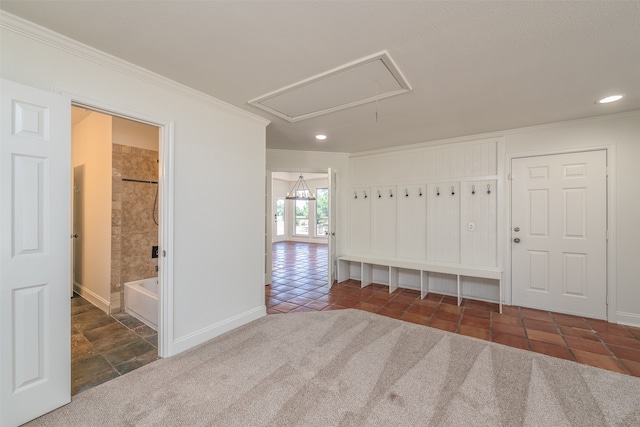 interior space with dark colored carpet, ensuite bath, and crown molding