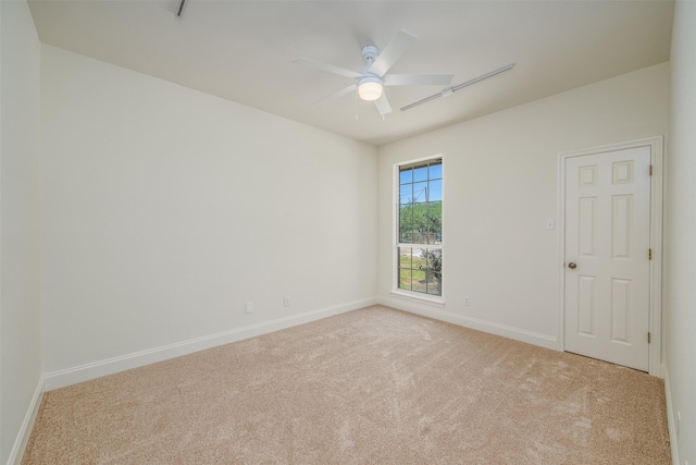 unfurnished room featuring light carpet and ceiling fan