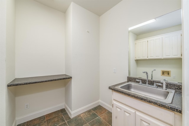 kitchen with white cabinetry and sink