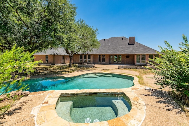 view of swimming pool with a patio area and an in ground hot tub