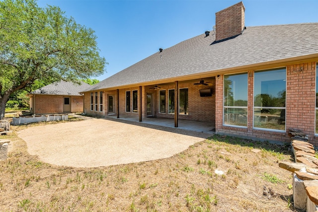 rear view of property featuring ceiling fan and a patio area