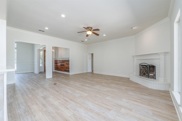 unfurnished living room featuring a fireplace, light hardwood / wood-style flooring, ceiling fan, and crown molding