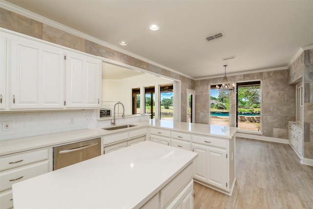 kitchen with sink, a kitchen island, and a healthy amount of sunlight