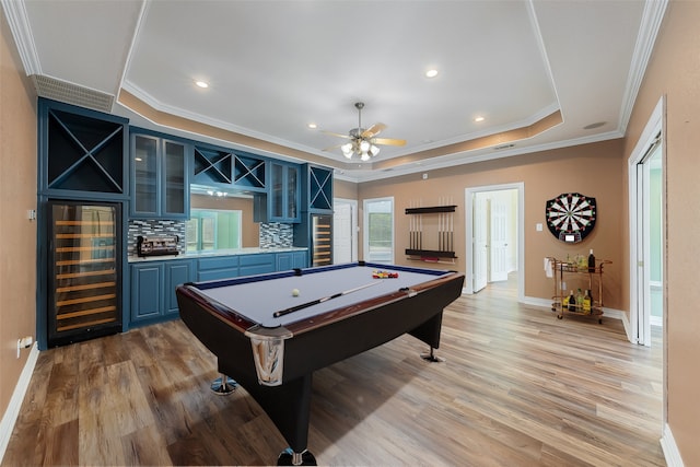 rec room with a tray ceiling, light hardwood / wood-style flooring, beverage cooler, and pool table