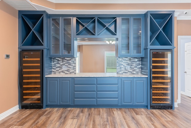 bar with decorative backsplash, crown molding, and beverage cooler