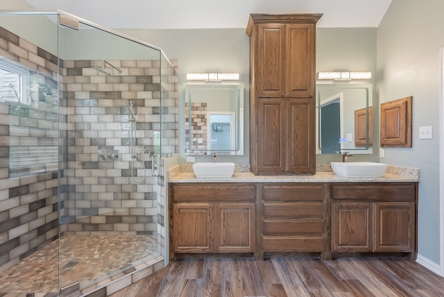 bathroom with hardwood / wood-style floors, vanity, and an enclosed shower