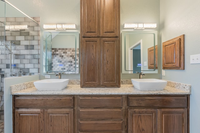 bathroom with a shower and vanity