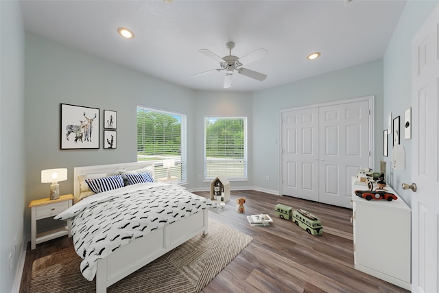 bedroom with ceiling fan, a closet, and hardwood / wood-style flooring