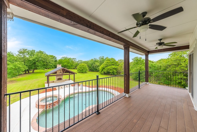 wooden deck with a swimming pool with hot tub, a gazebo, ceiling fan, and a lawn