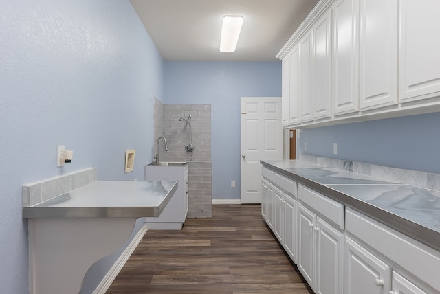 laundry area featuring sink, cabinets, dark wood-type flooring, and hookup for a washing machine