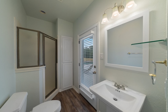 bathroom featuring hardwood / wood-style flooring, vanity, toilet, and an enclosed shower