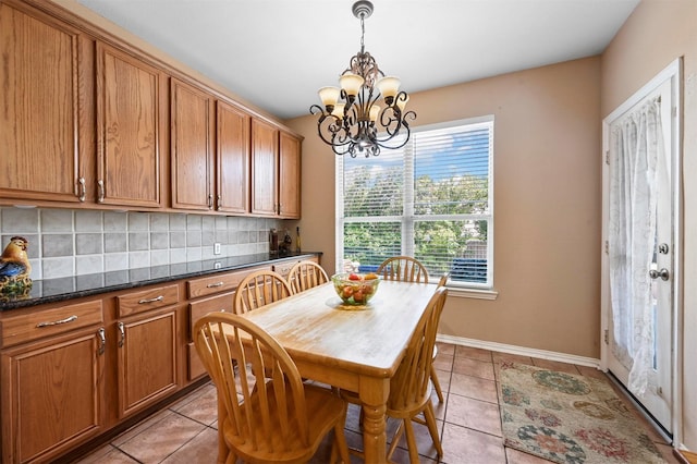 tiled dining room with a chandelier