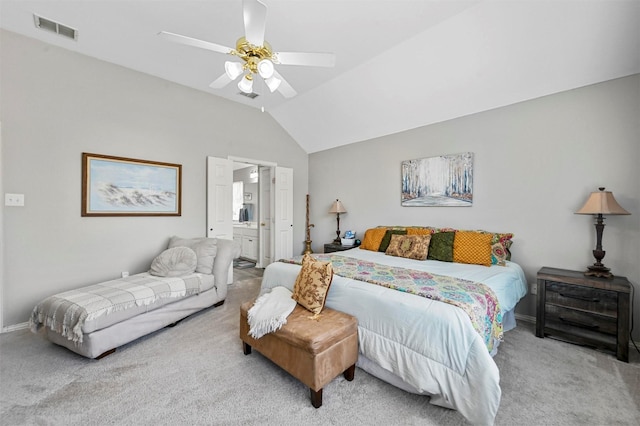 carpeted bedroom with connected bathroom, ceiling fan, and vaulted ceiling