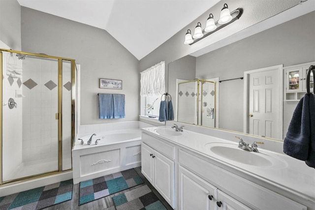 bathroom with vanity, shower with separate bathtub, and vaulted ceiling