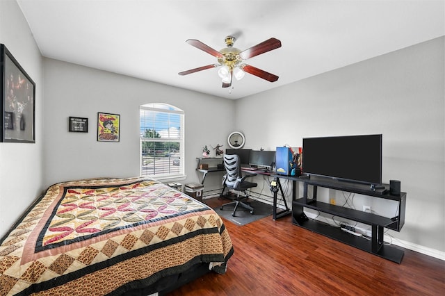 bedroom featuring hardwood / wood-style floors, ceiling fan, and baseboard heating