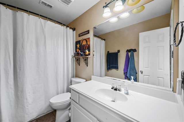 bathroom featuring tile patterned floors, vanity, and toilet