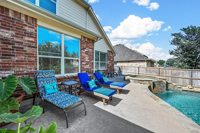 view of patio / terrace with a swimming pool with hot tub and pool water feature