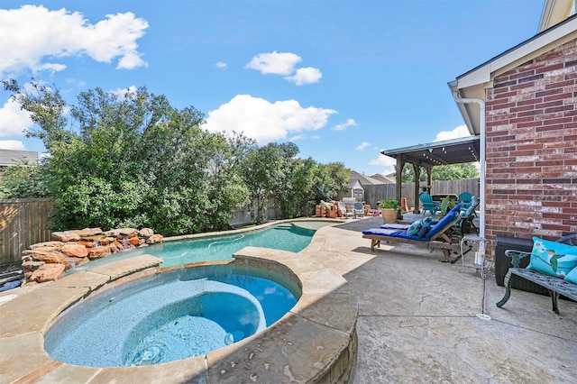 view of pool with an in ground hot tub and a patio