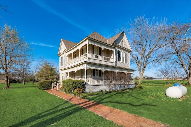 view of property exterior featuring a porch, a balcony, and a yard