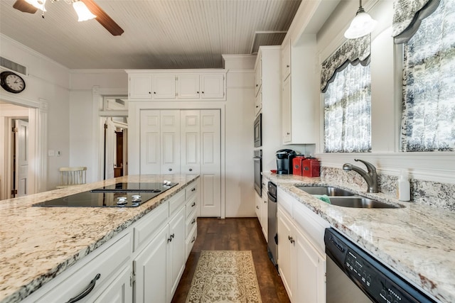 kitchen with hanging light fixtures, white cabinetry, sink, and appliances with stainless steel finishes