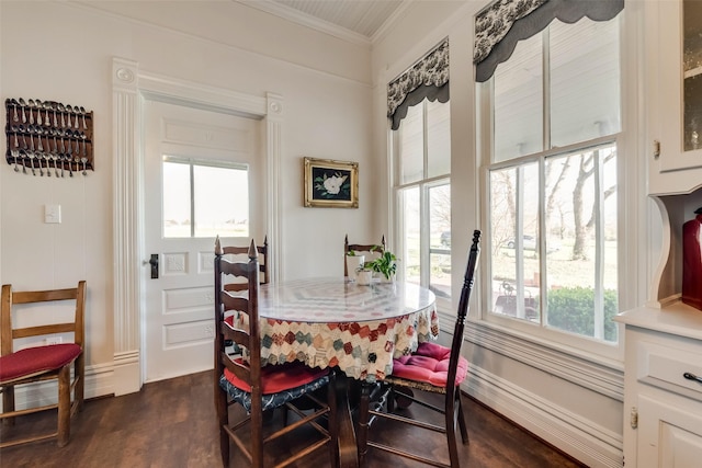 dining area featuring crown molding and dark wood-type flooring