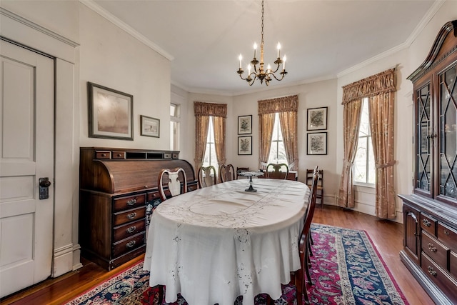 dining room with a chandelier, dark hardwood / wood-style flooring, and crown molding