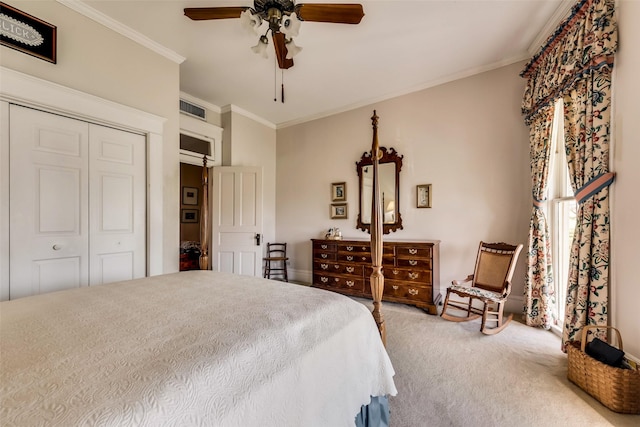 carpeted bedroom with ceiling fan, ornamental molding, and a closet