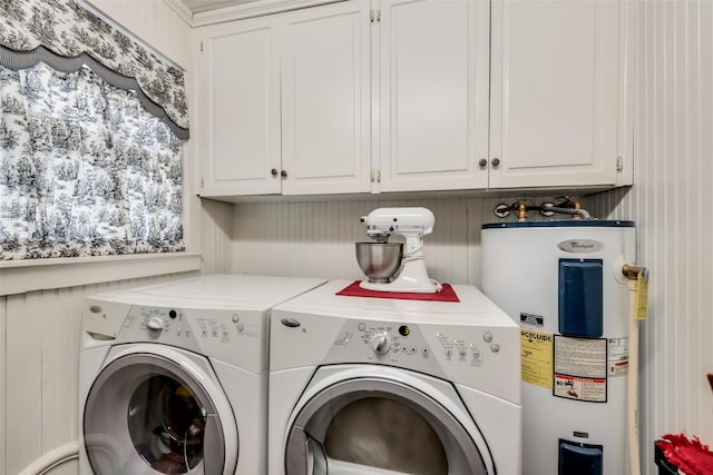 washroom with cabinets, electric water heater, and washer and clothes dryer