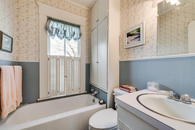 bathroom featuring vanity, toilet, and a bath