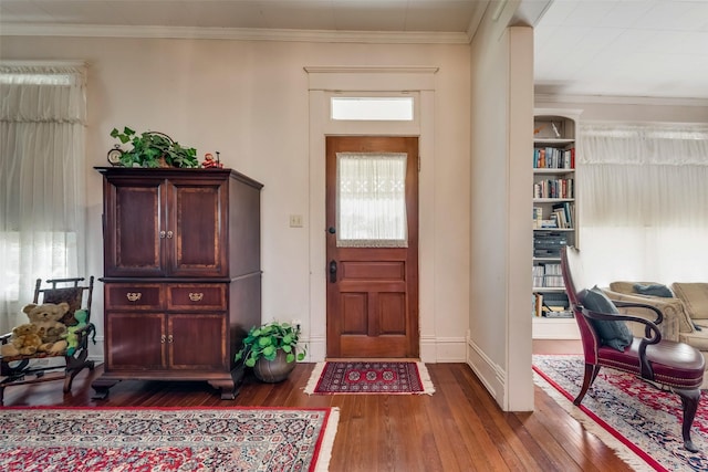 entrance foyer featuring dark hardwood / wood-style floors and ornamental molding