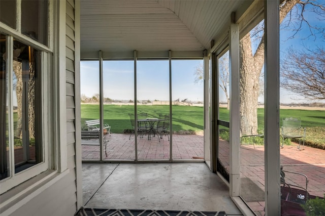 unfurnished sunroom with plenty of natural light and lofted ceiling